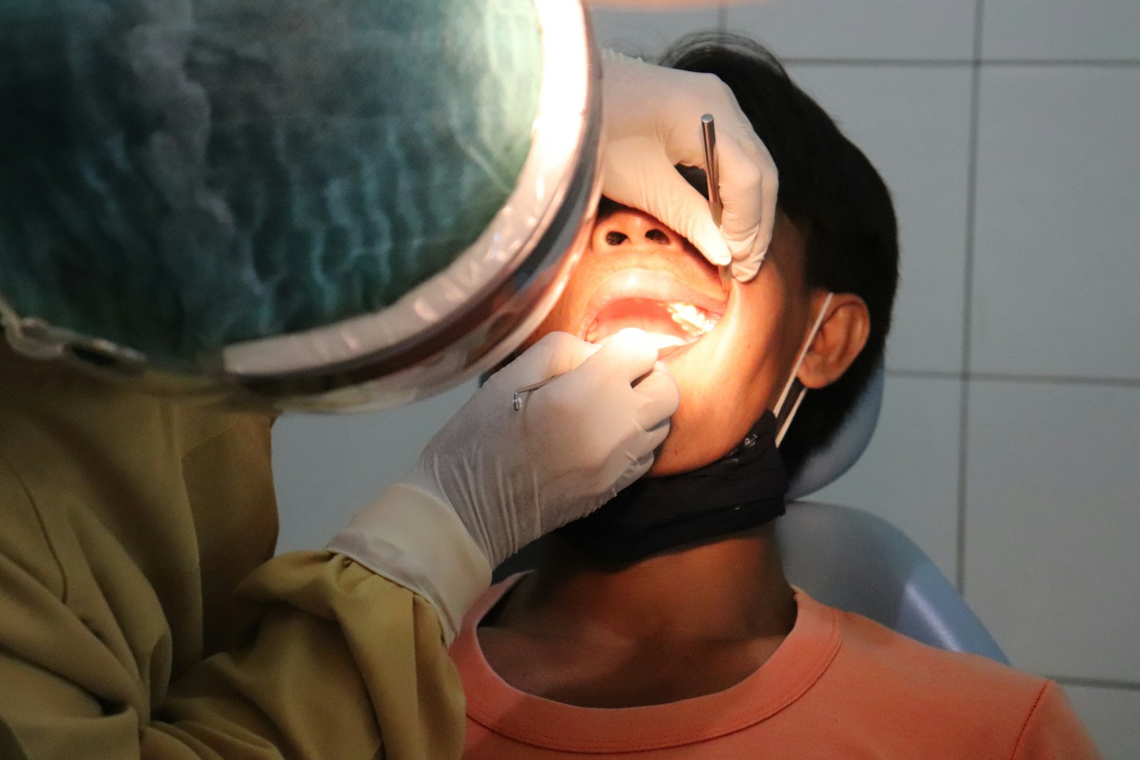 un homme se fait examiner les dents par un dentiste